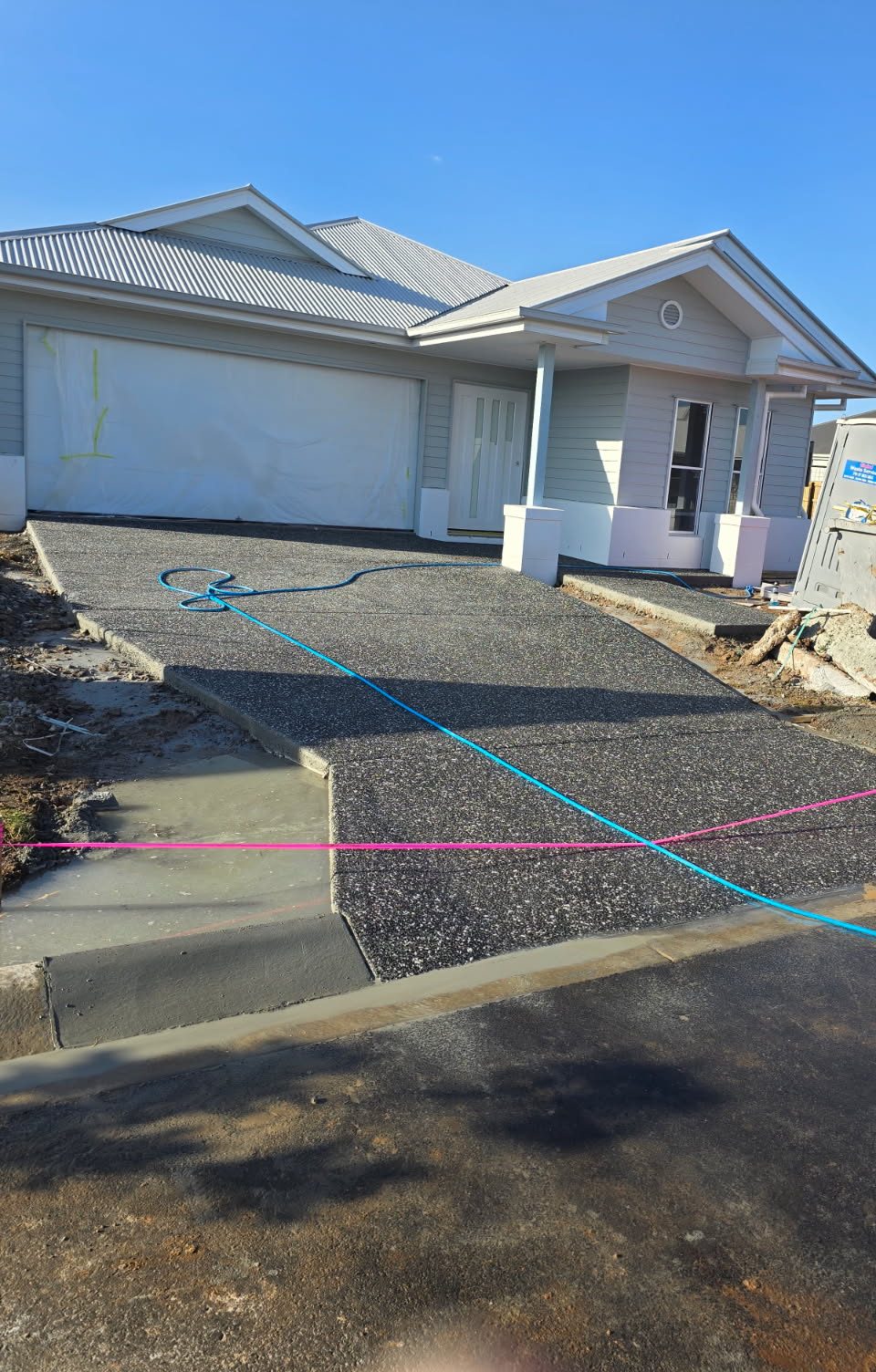 Charcoal exposed aggregate driveway at a newly built home