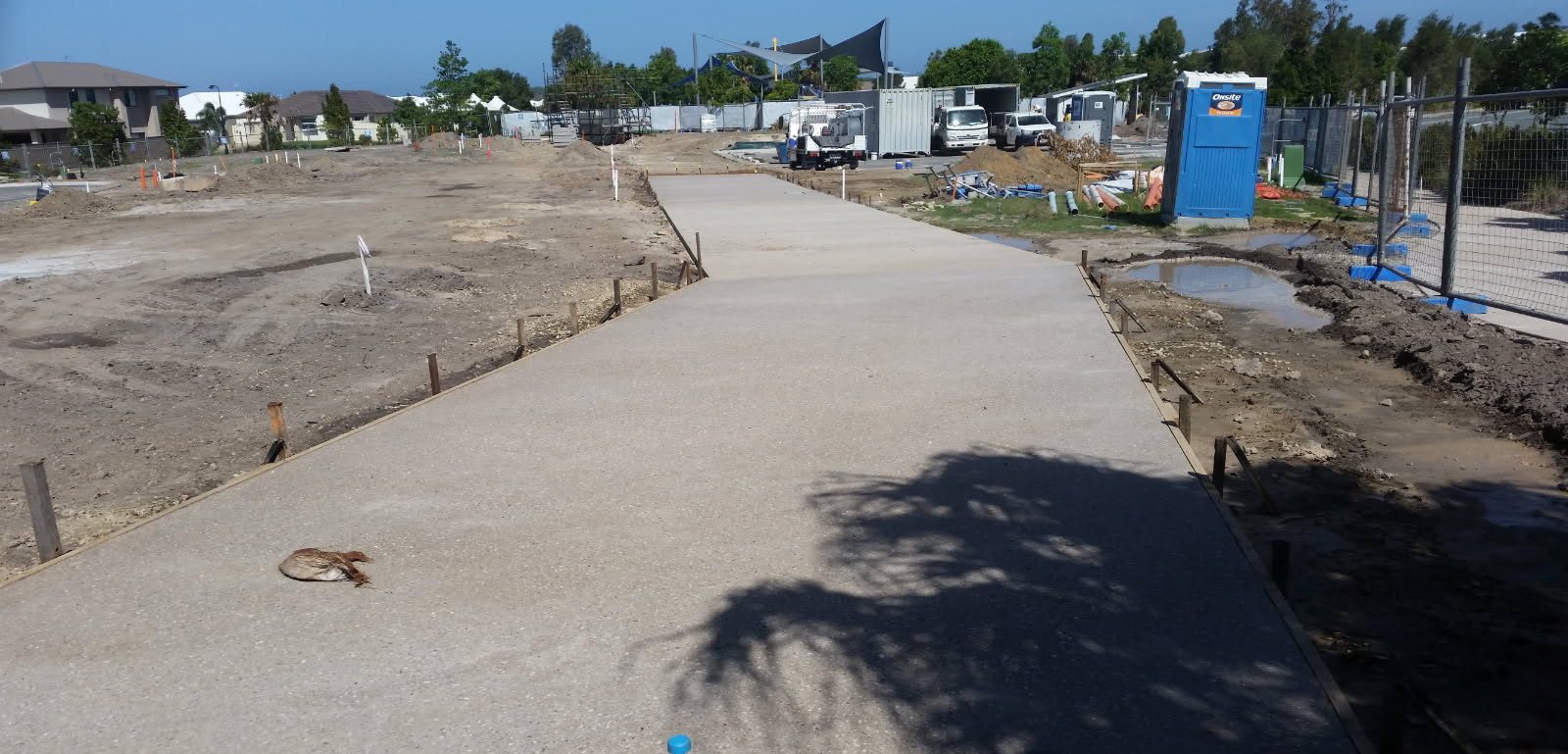 Long run of pale exposed aggregate poured and washed in planned sections
